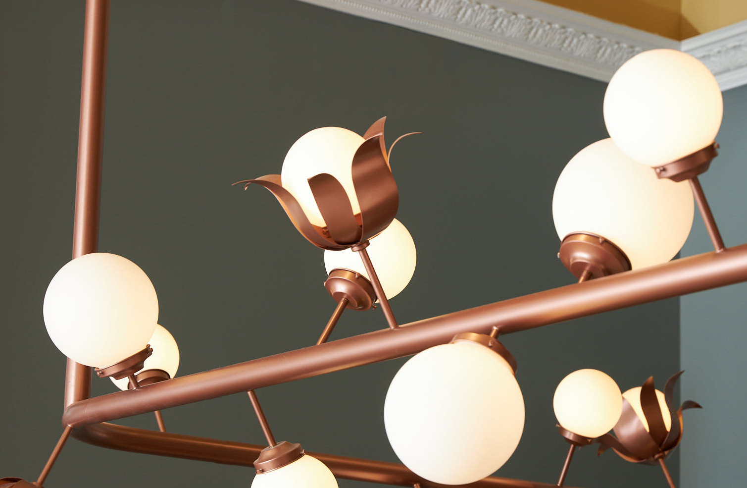 Custom copper light fixture hanging over the bar in Linh Cafe