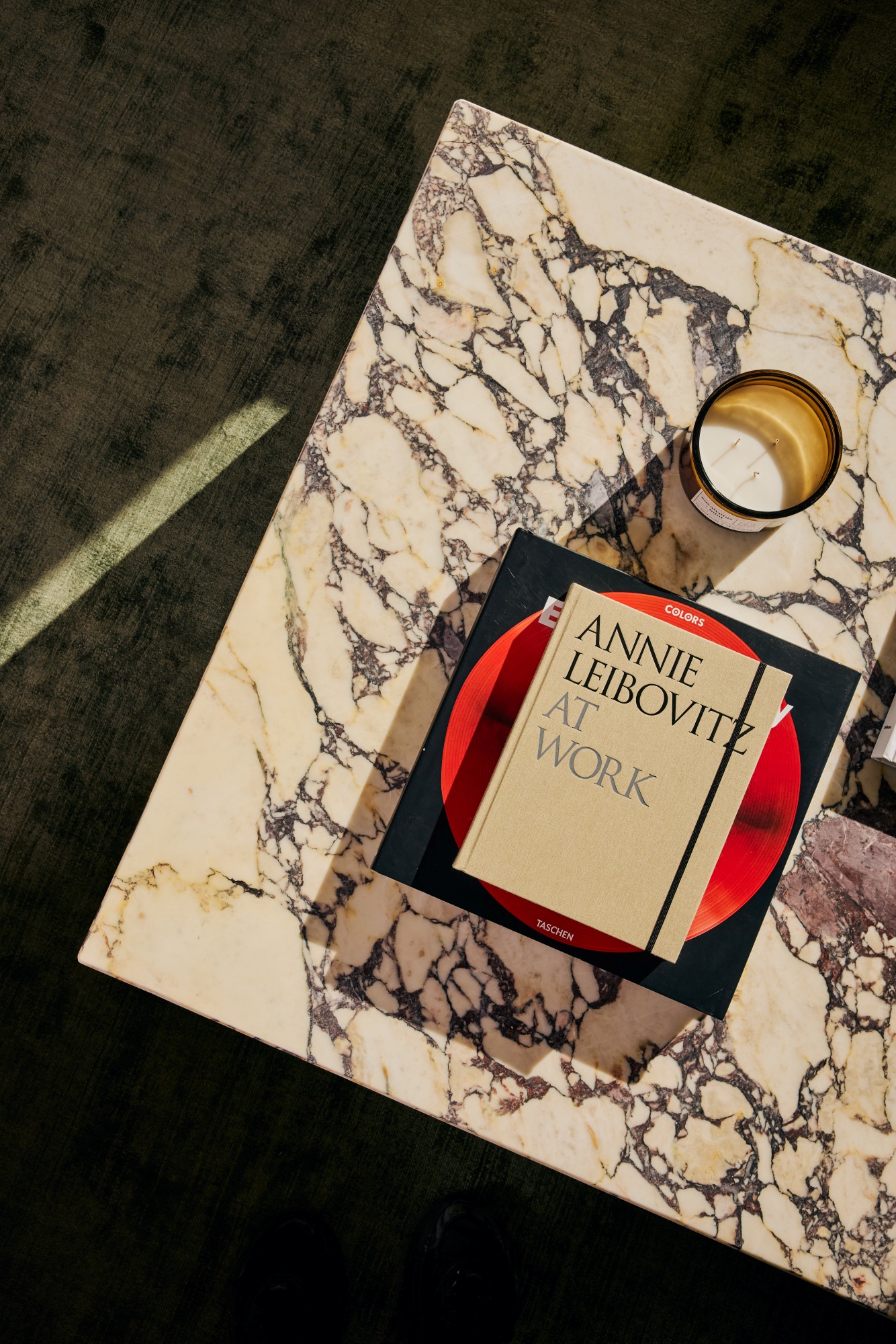 Custom marble coffee table with Annie Leibovitz At Work book and candle.