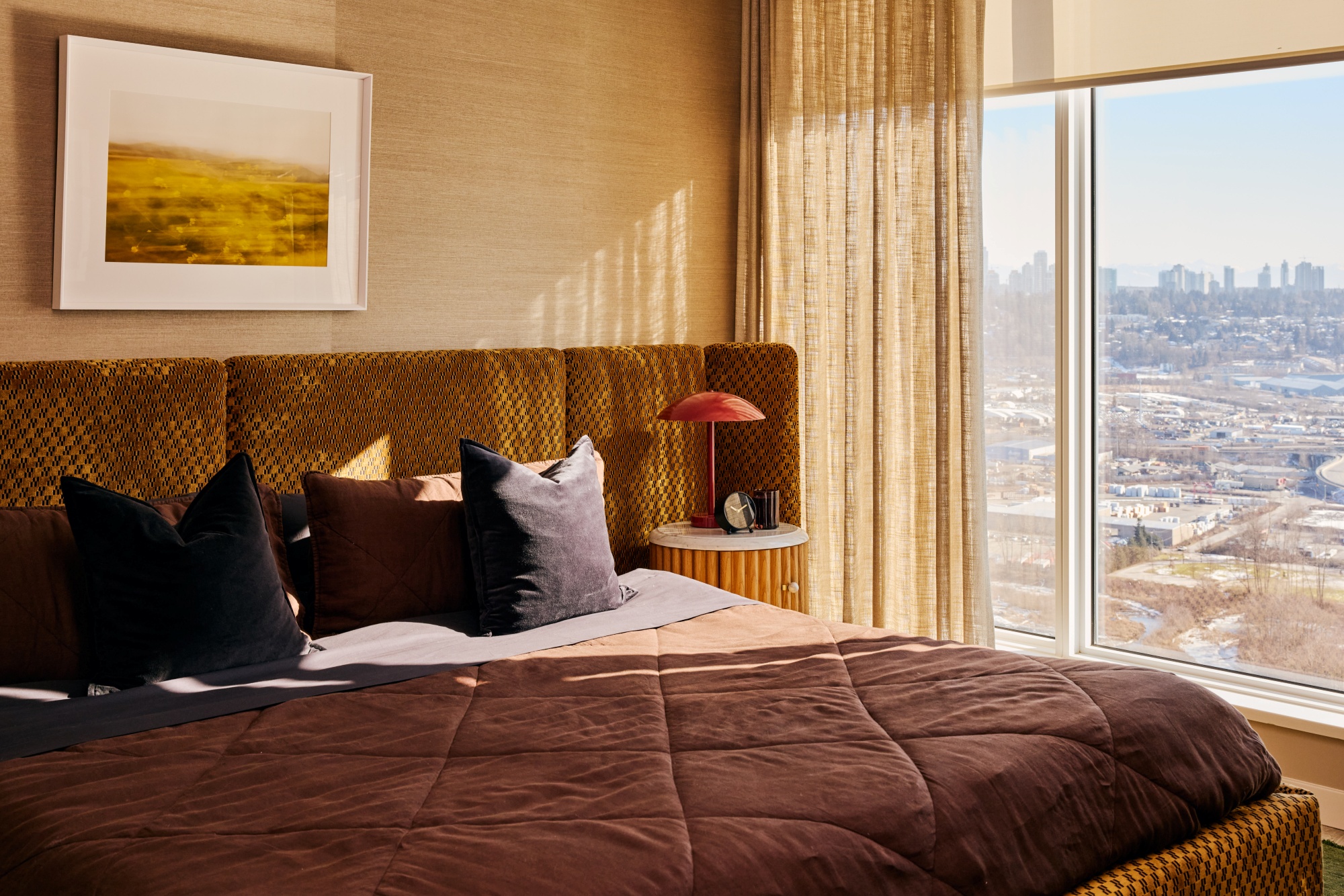 Primary bedroom with a custom bed and black bedding.
