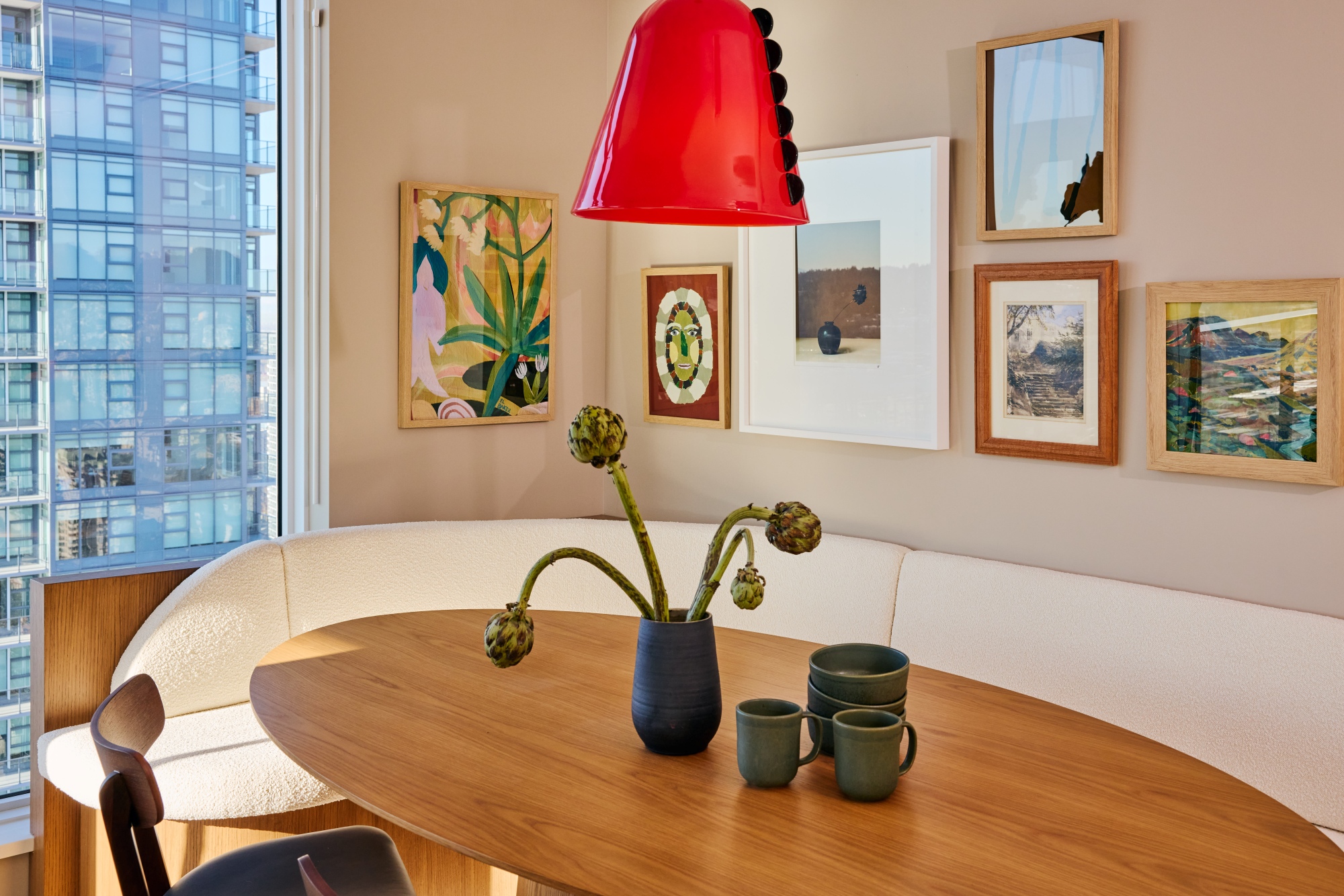 Dining Room gallery wall with glass red In Common With pendent light.